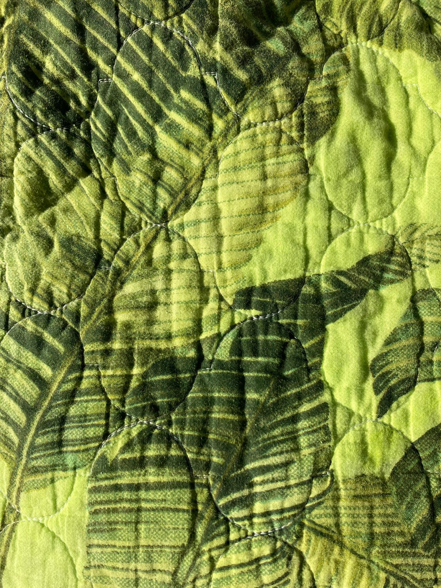 Close-up of the tropical print on the lime tropical pet pillow.