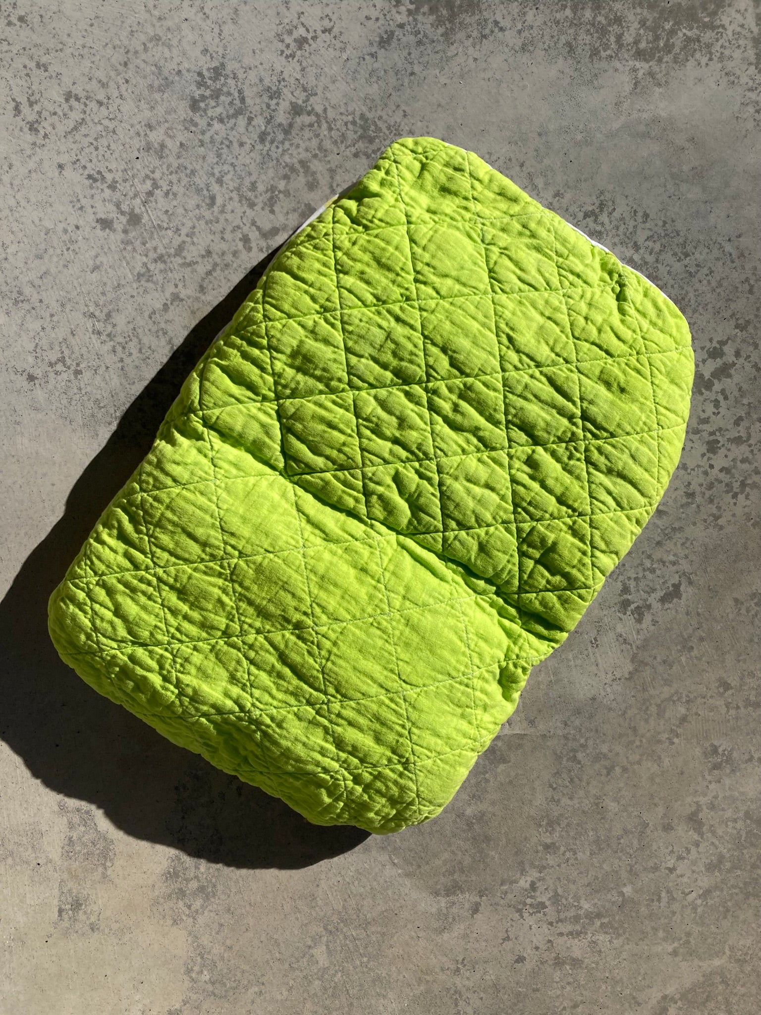 Hand dyed lime green pet pillow, quilted in windowpane pattern.