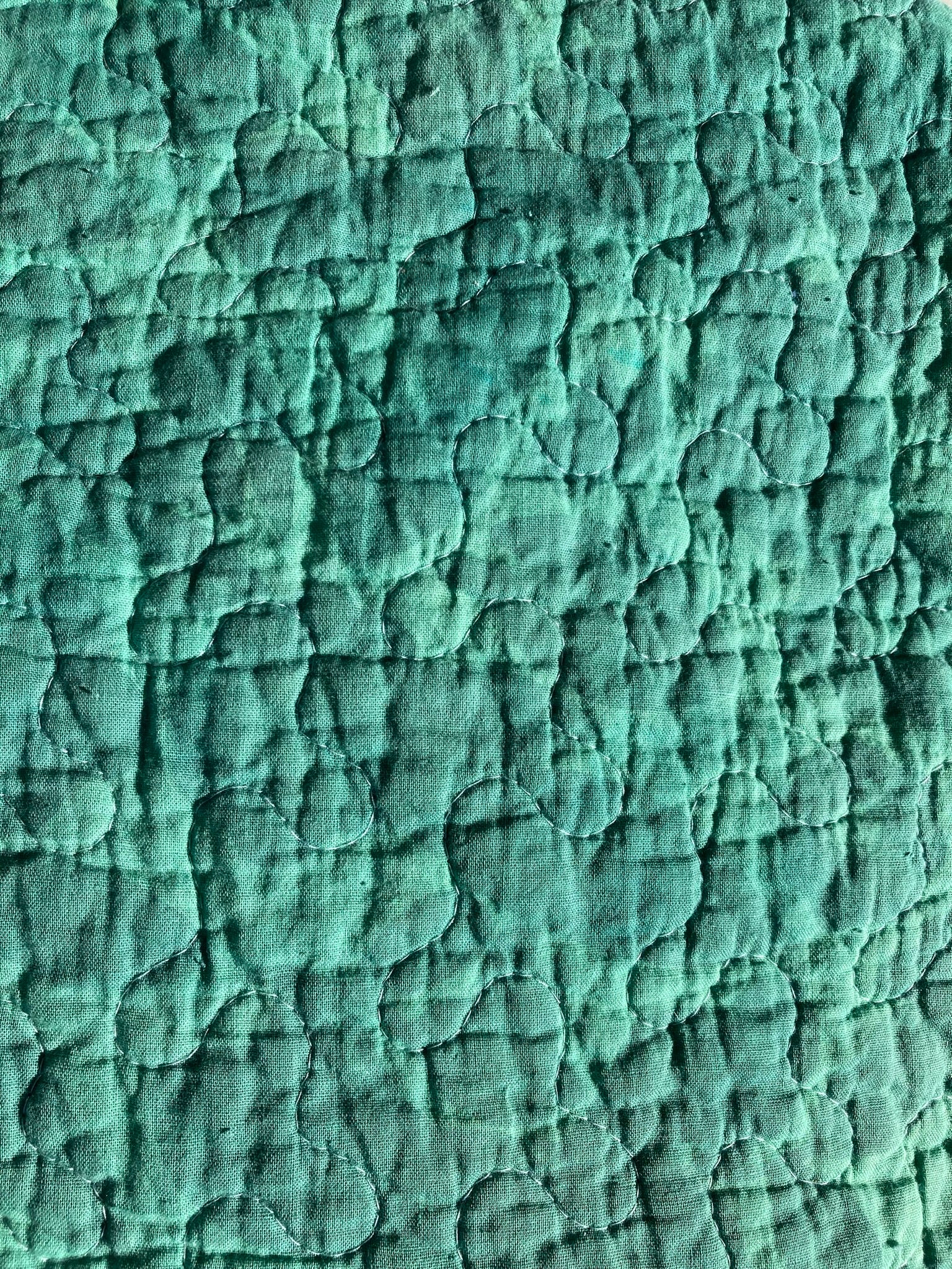 Close-up of the emerald pet pillow. This shows the faint floral print of the top and the random squiggle quilting pattern.